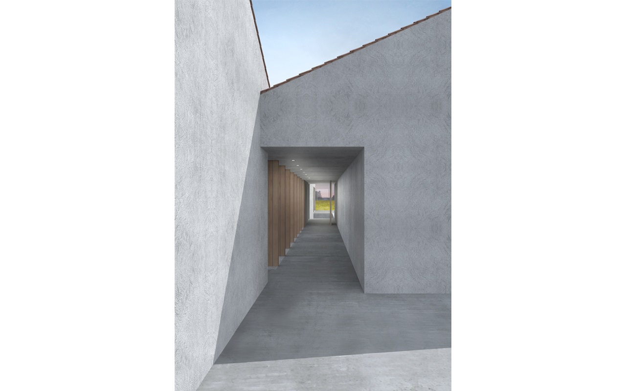  Villa singola dal carattere vernacolare nella campagna padovana, su un unico livello con tetto spiovente e materiali tradizionali. Un'apertura dalle linee essenziali conduce al camminamento coperto, accompagnato da un colonnato in legno che si affaccia sul patio interno, e conduce all'ingresso 