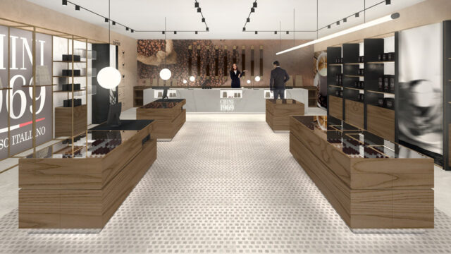Interior design di una caffè boutique con finiture calde e raffinate, arredo su misura in legno di noce e metallo ottonato, che crea un'atmosfera contemporanea e richiama l'esperienza olfattiva delle miscele di caffè pregiate.